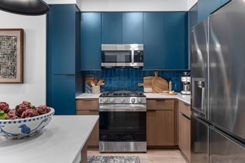 Energy efficient appliances including side-by-side refrigerators* with water and ice dispenser and gas slide in ranges